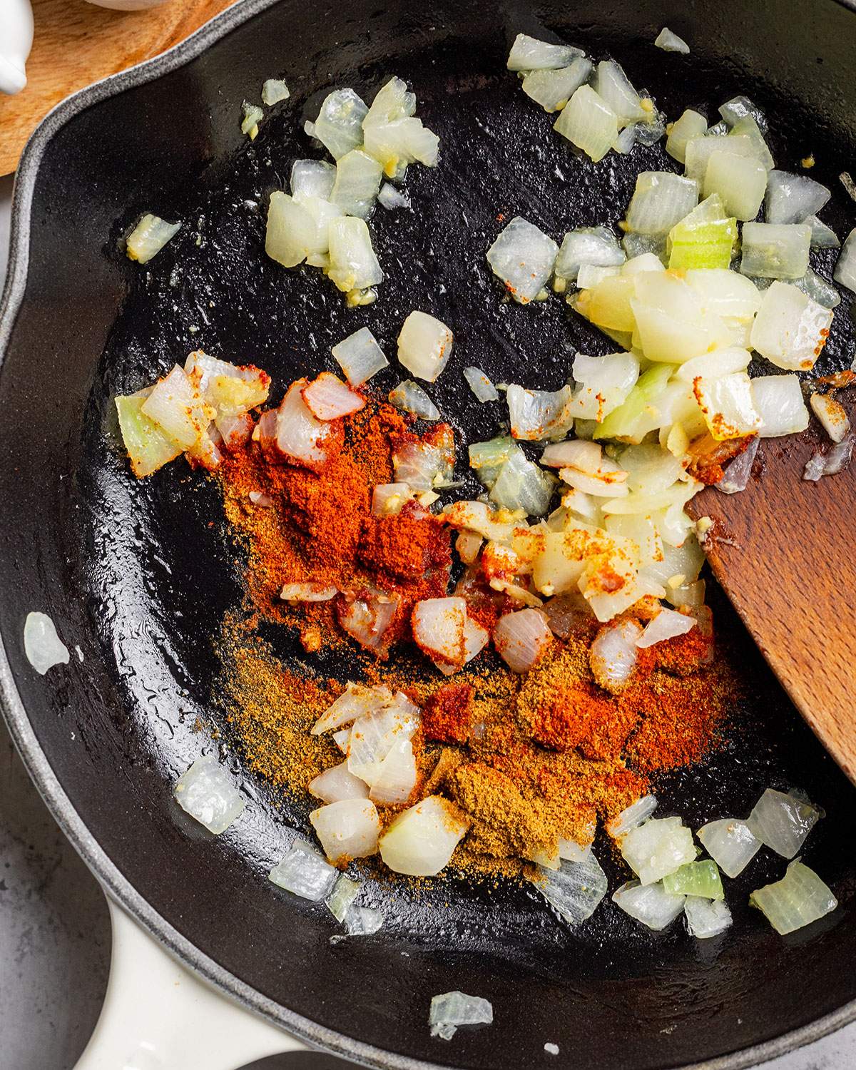 Sautêed onions with spices in a skillet.