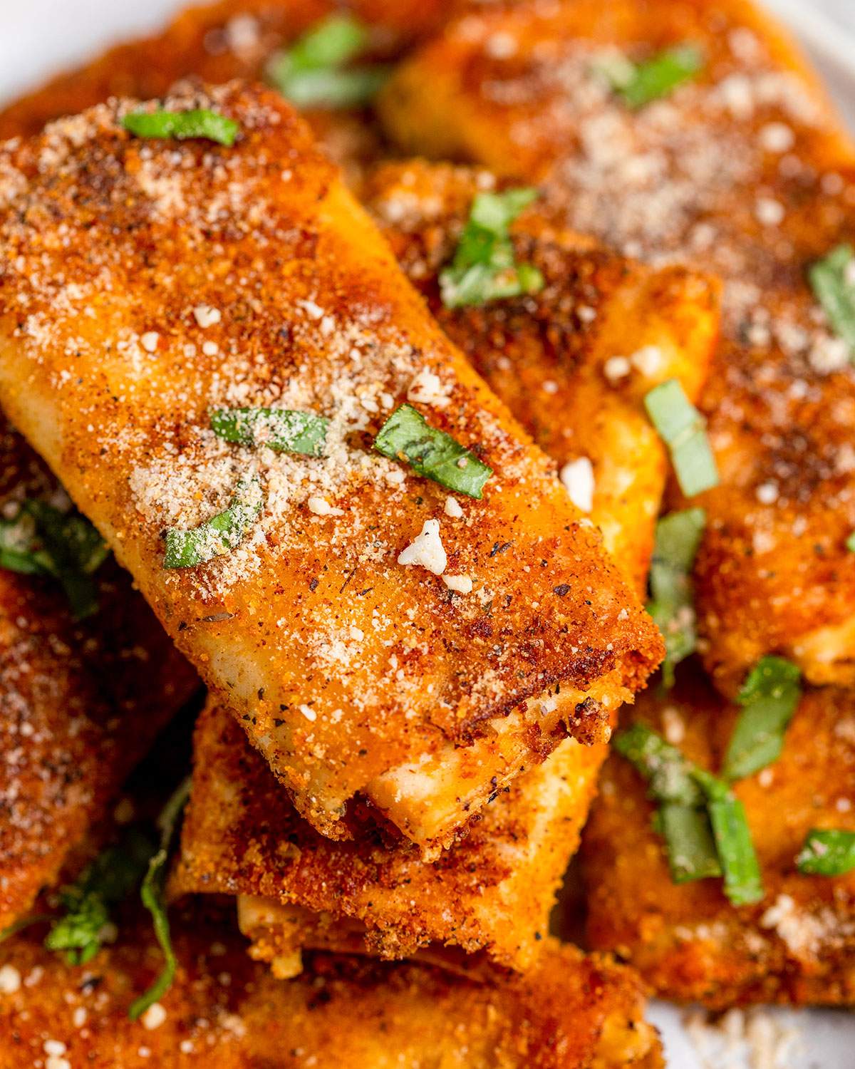 Close up crispy lasagna roll on a serving platter.