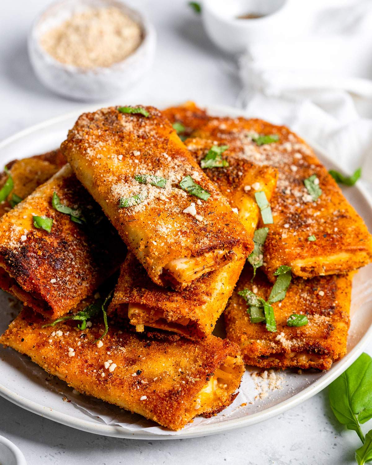 Crispy lasagna rolls on a serving plate.