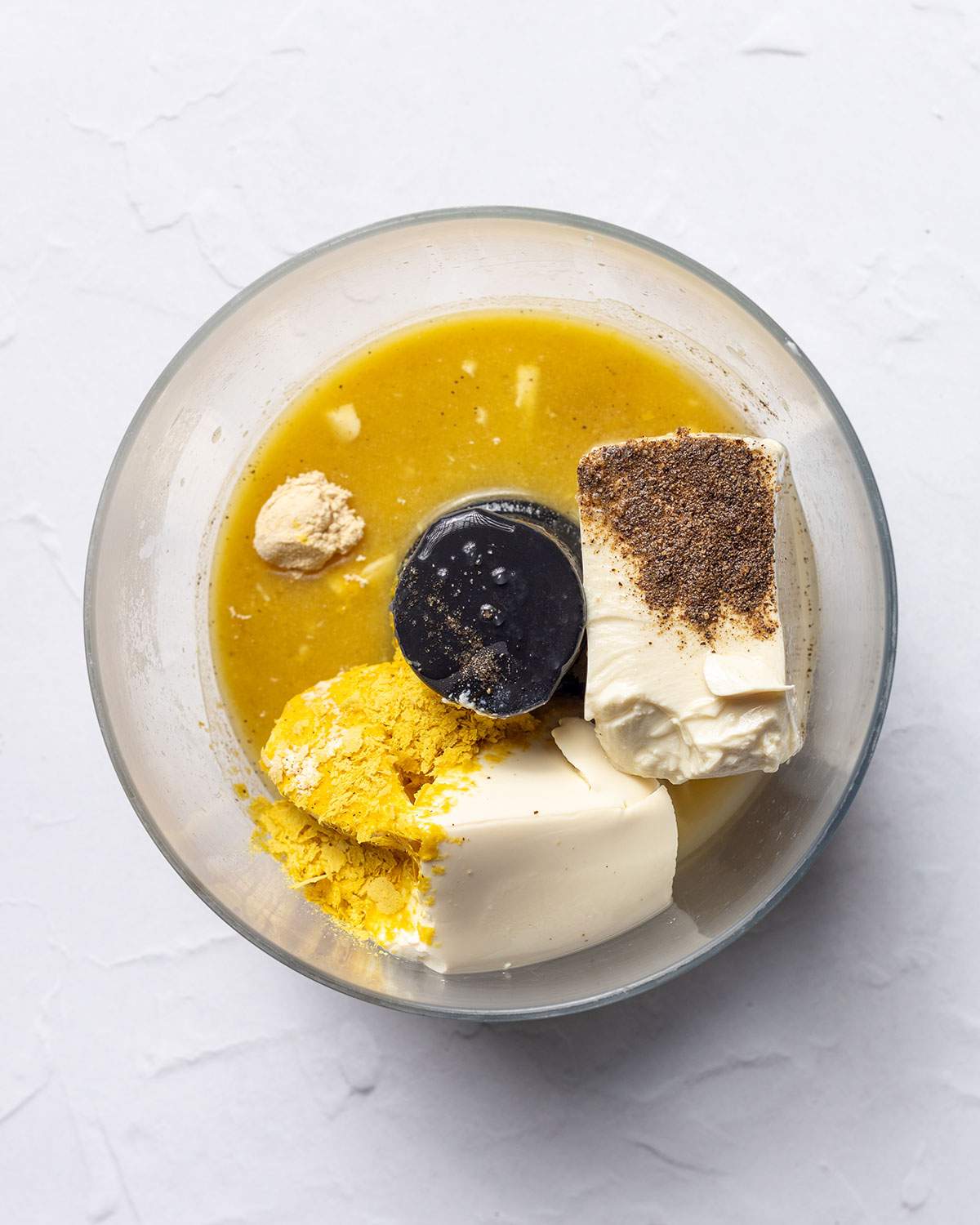 Ingredients for tofu sour cream in a food processor.
