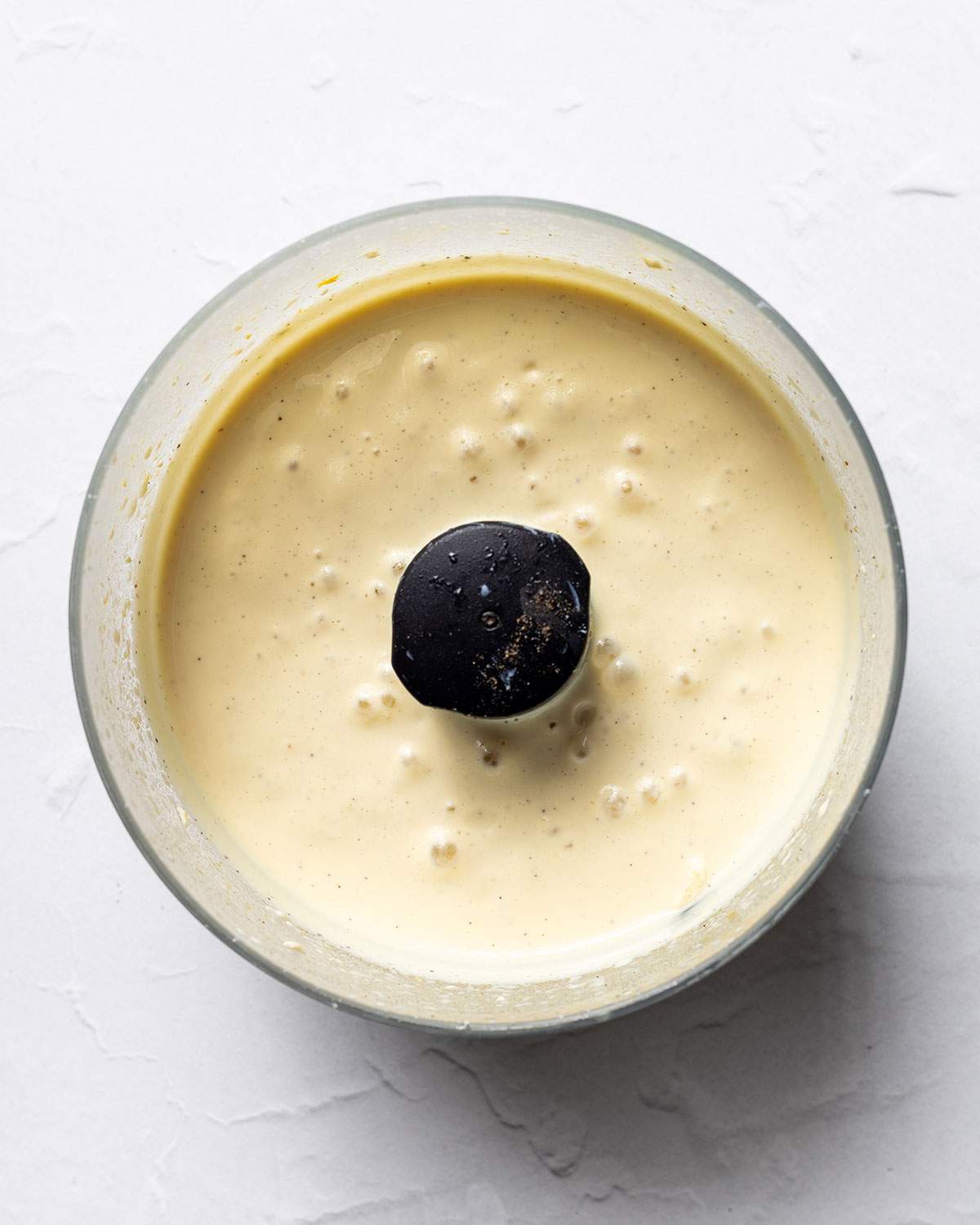 Smooth and creamy vegan sour cream in a food processor.