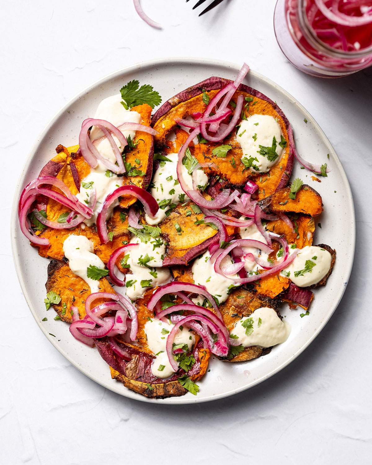 Dollops of tofu sour cream on baked potatoes.
