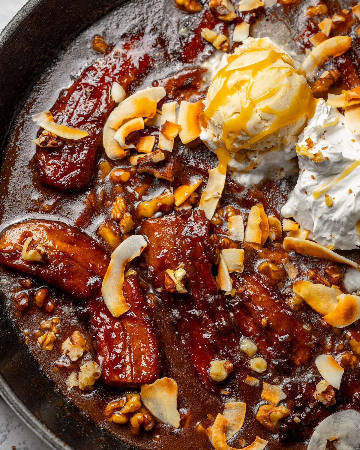 Caramelized bananas on top of a bananas foster skillet.