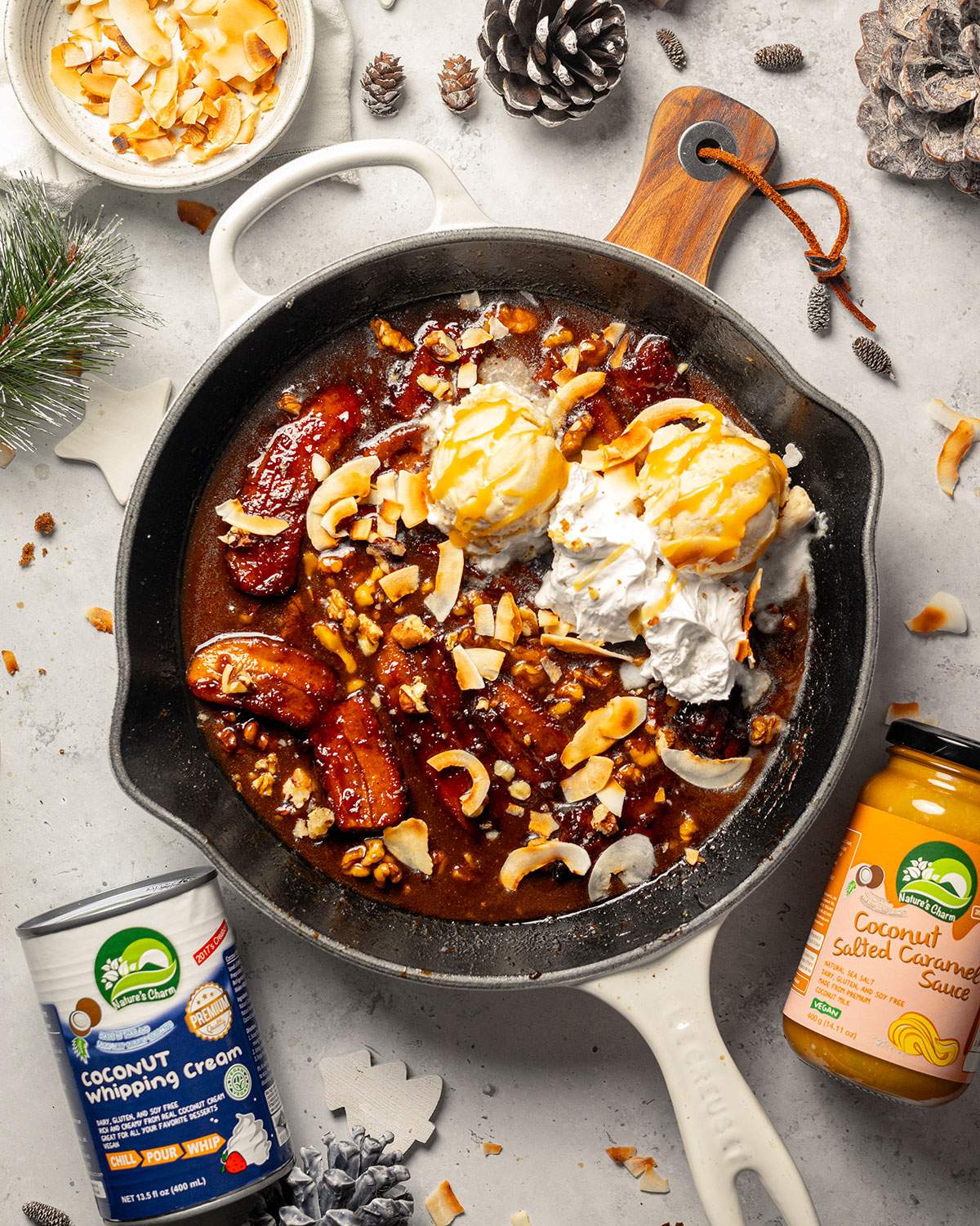 Bananas Foster in a skillet, surrounded by ingredients.