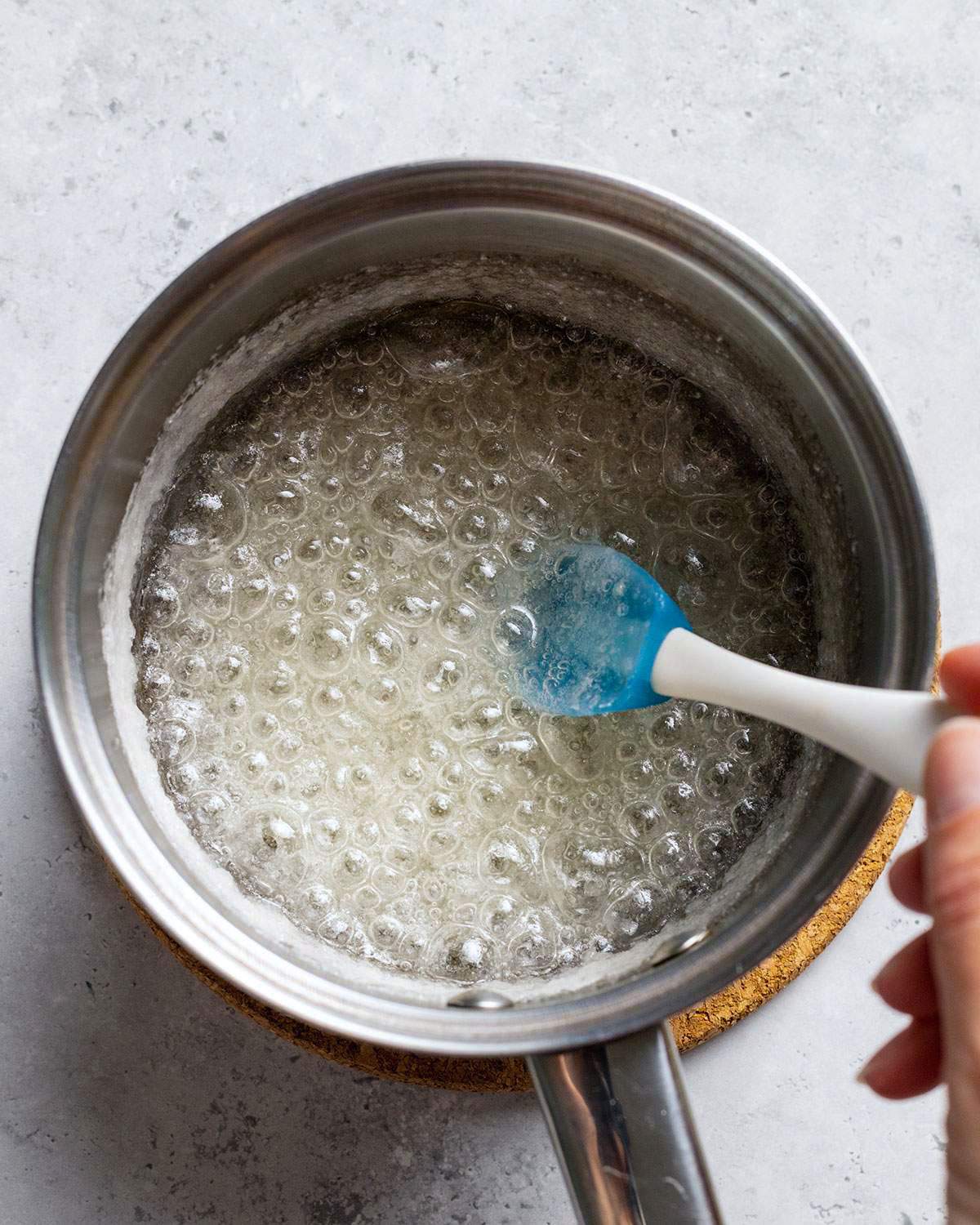 Bubbling melted sugar in a saucepan.