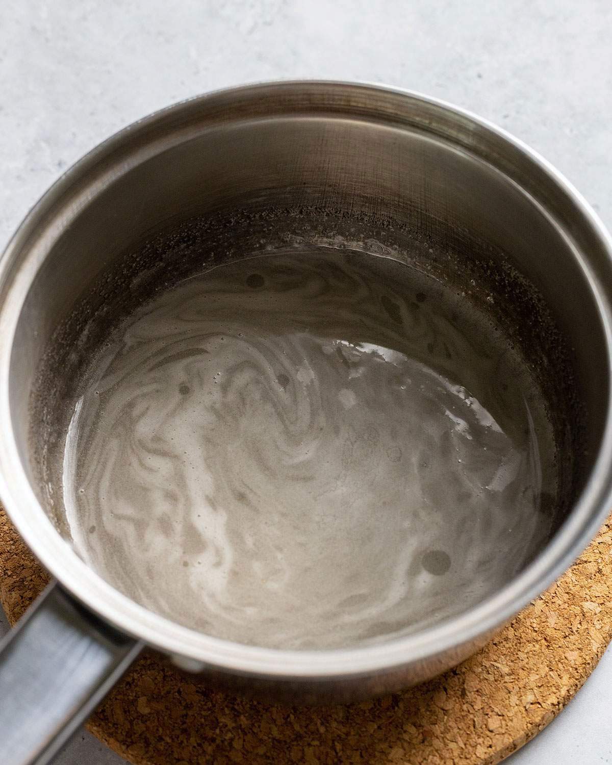 Melted sugar in a saucepan.