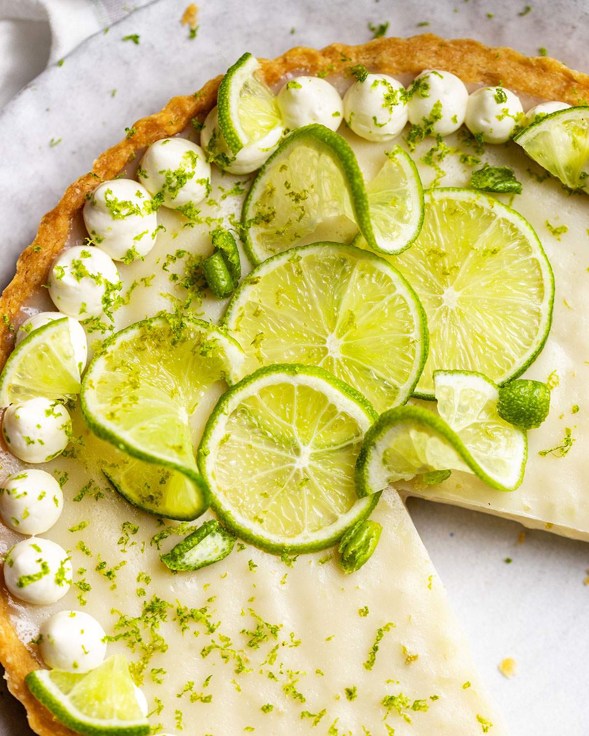 Thinly sliced limes decorated on a vegan key lime pie.