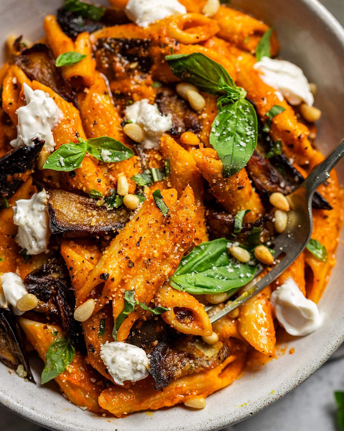Vegan penne up close in a bowl.
