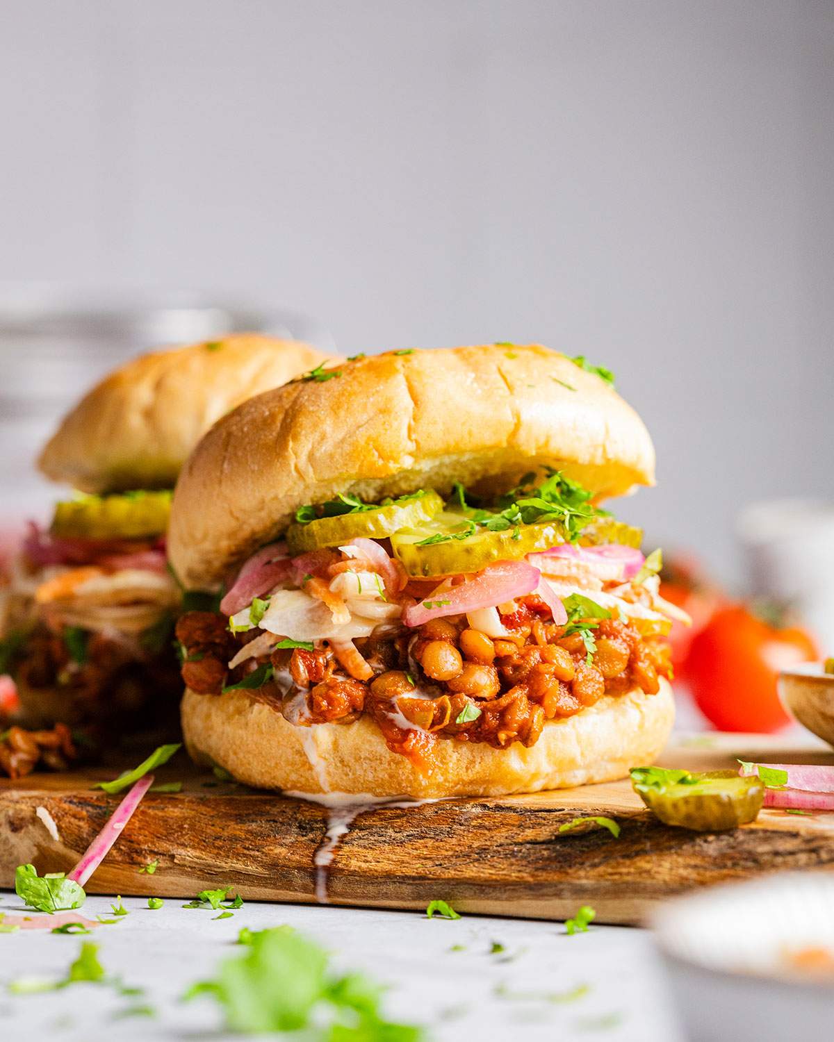 Vegan lentil sloppy joe burger on a board.