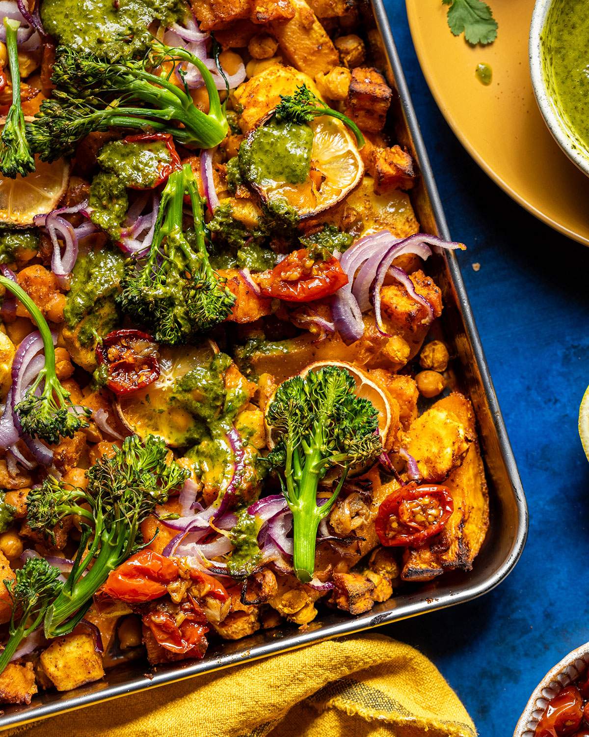 Vibrant green broccoli on top of a chickpea traybake.