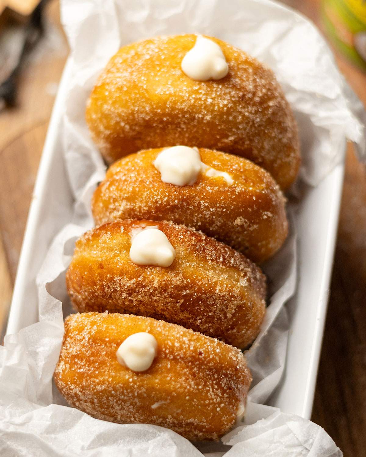 Vegan coconut custard donuts in a tray.