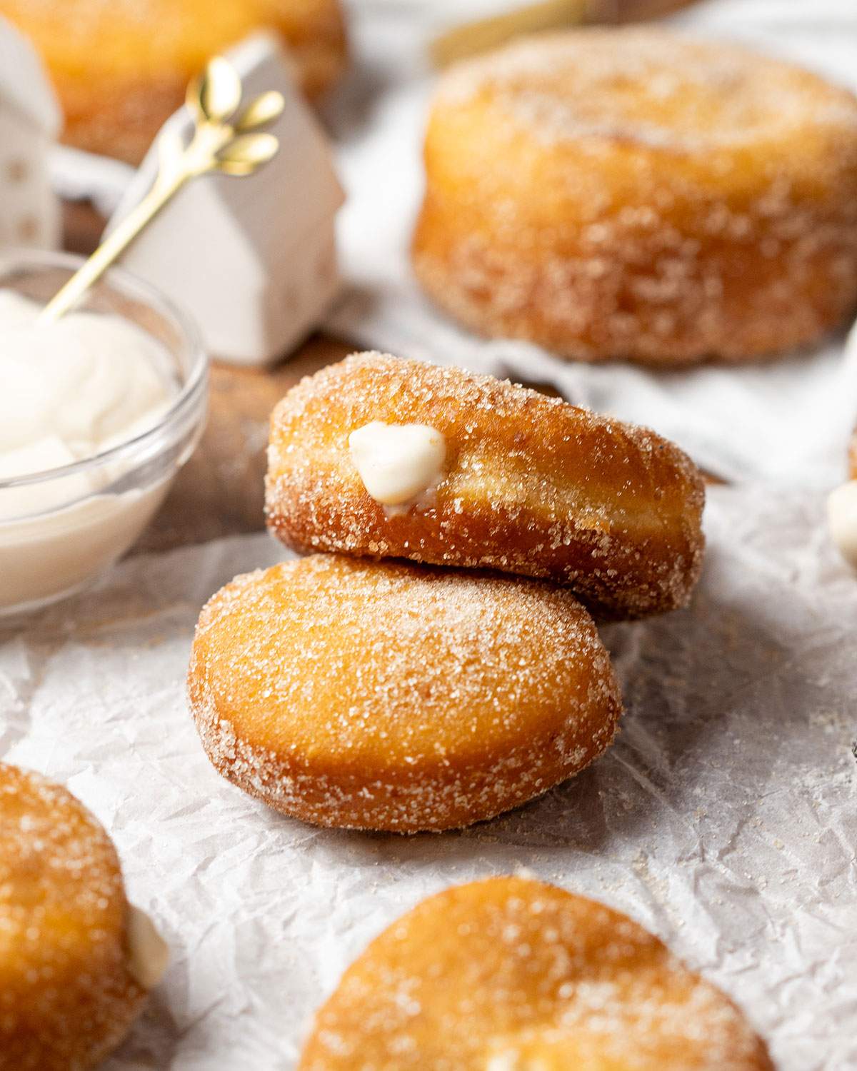 Two fluffy vegan donuts filled with custard stacked.