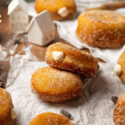 Vegan custard donuts on a parchment paper.