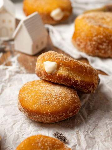 Vegan custard donuts on a parchment paper.