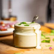 Creamy tofu sour cream in an open jar.