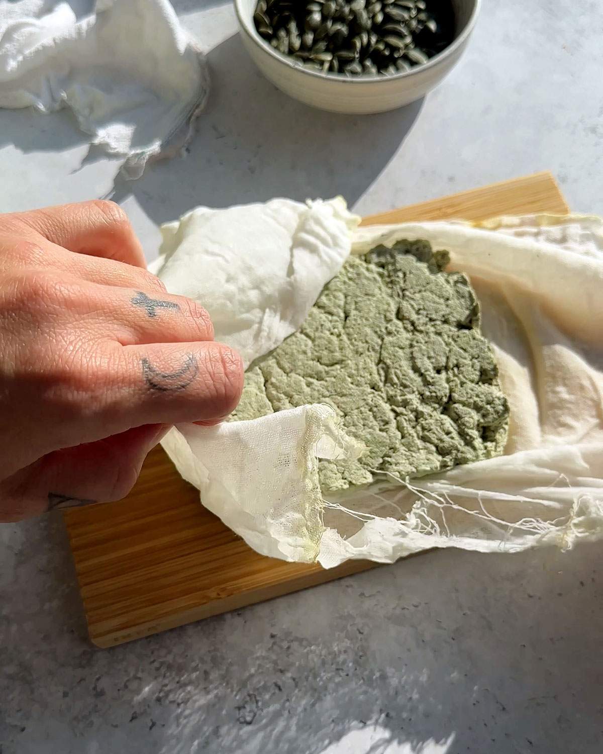 Unwrapping a block of pumfu tofu from a cloth.