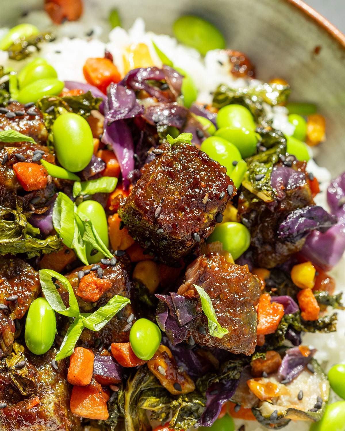 Coated pumfu tofu cubes on a stir fry.