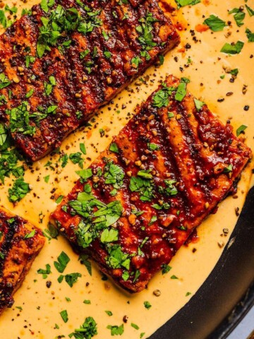 Cajun tofu steaks in a skillet.