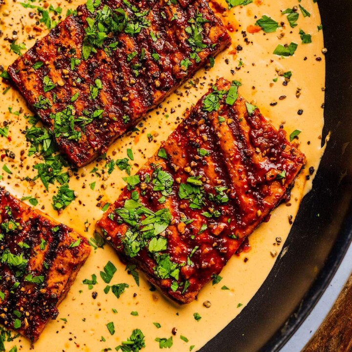 Cajun tofu steaks in a skillet.
