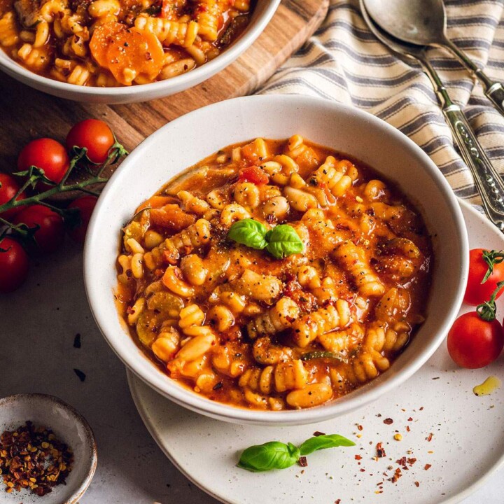 A bowl of plant based minestrone on the dinner table.