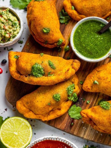 Air fryer empanadas on a serving board.