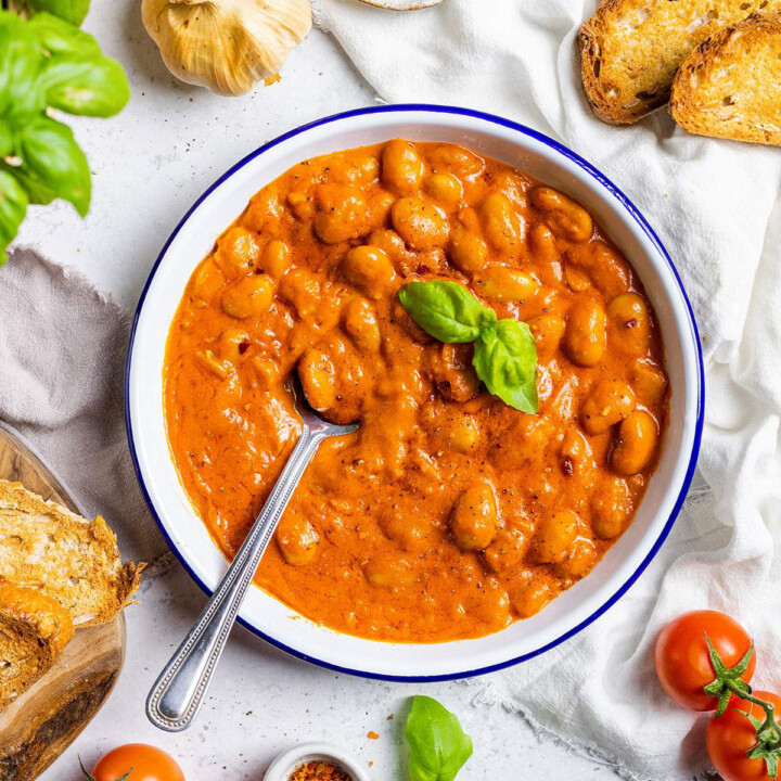 Creamy Butter Beans Alla Vodka on a plate with a spoon.
