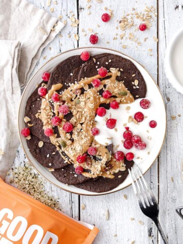 Hemp protein pancakes with fruit and nut butter on the breakfast table.