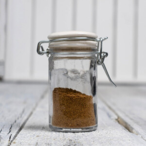 Homemade pumpkin spice seasoning mix in a small jar.