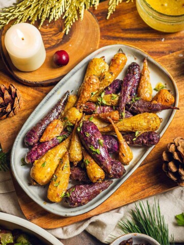 Roasted rainbow carrots on a serving tray.