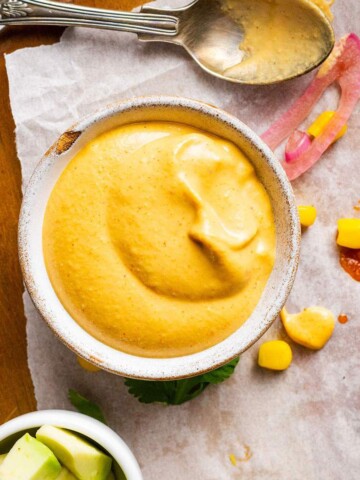 A small ramekin of vegan nacho cheese sauce.