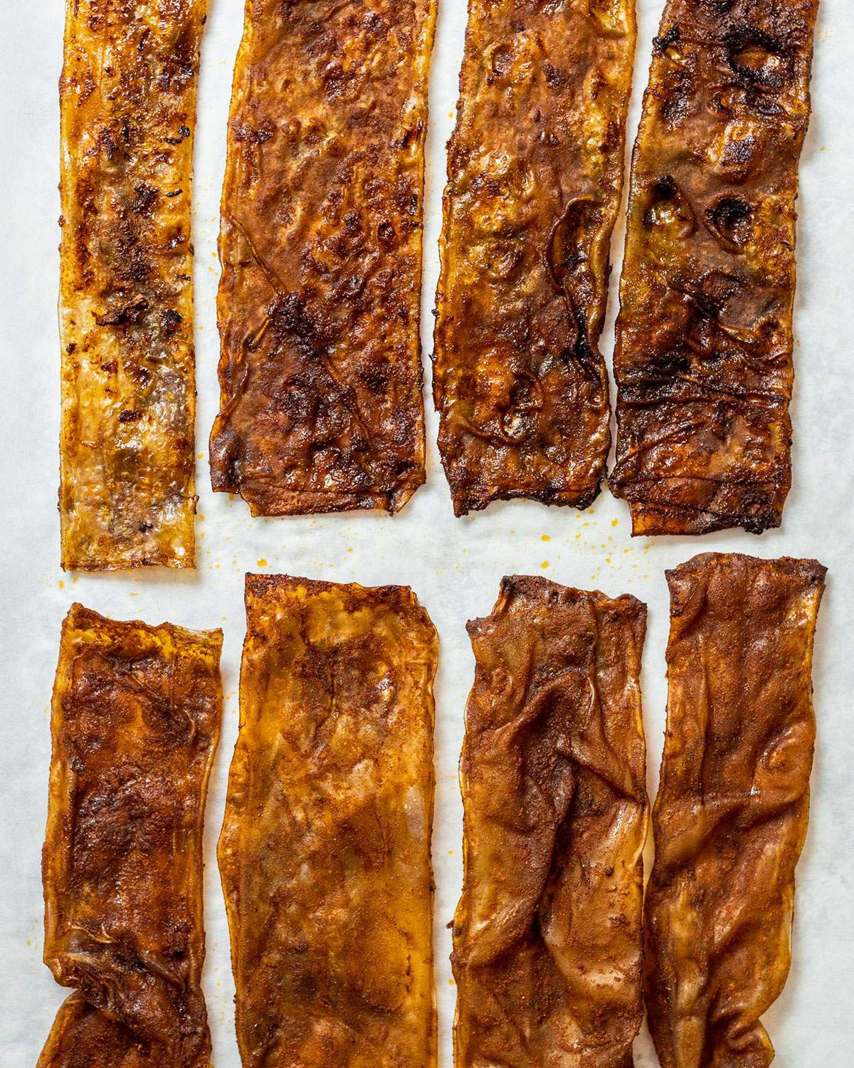 Vegan rice paper Bacon strips on a baking parchment.