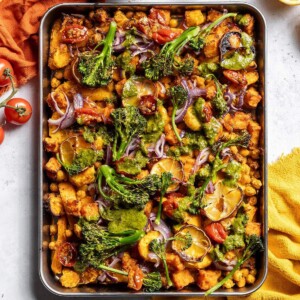 Roasted vegetables and chickpeas on a baking tray.