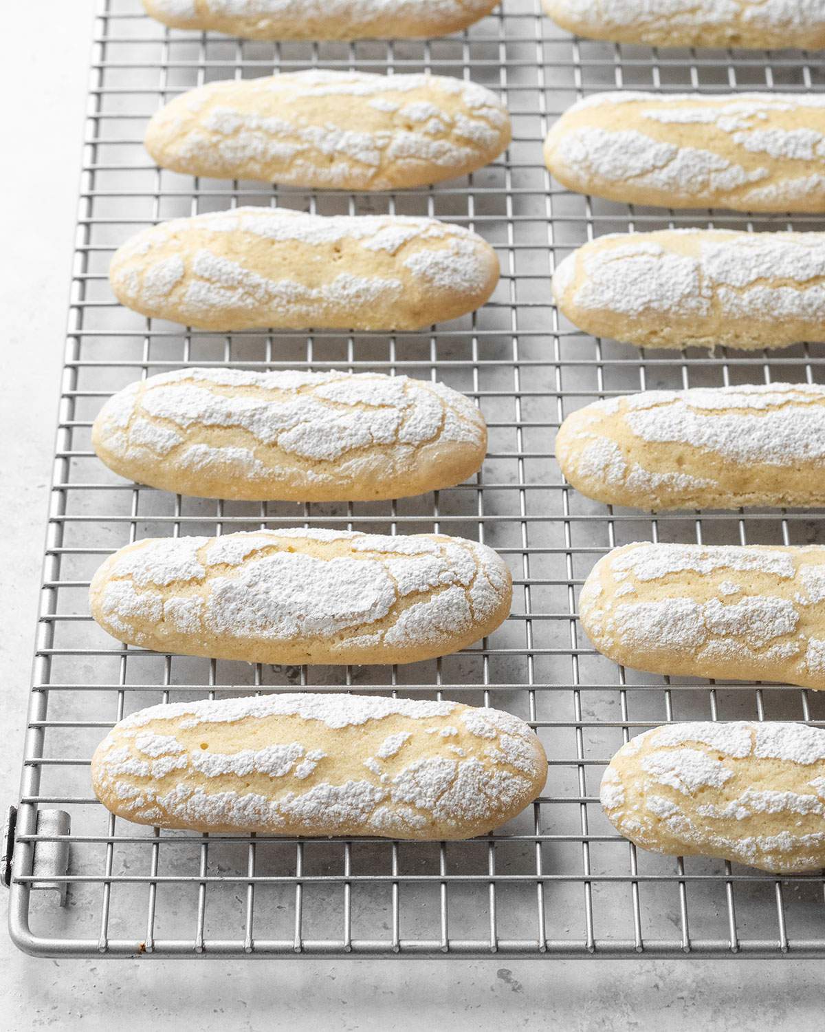 Vegan Ladyfingers cooling down on a cooling rack.