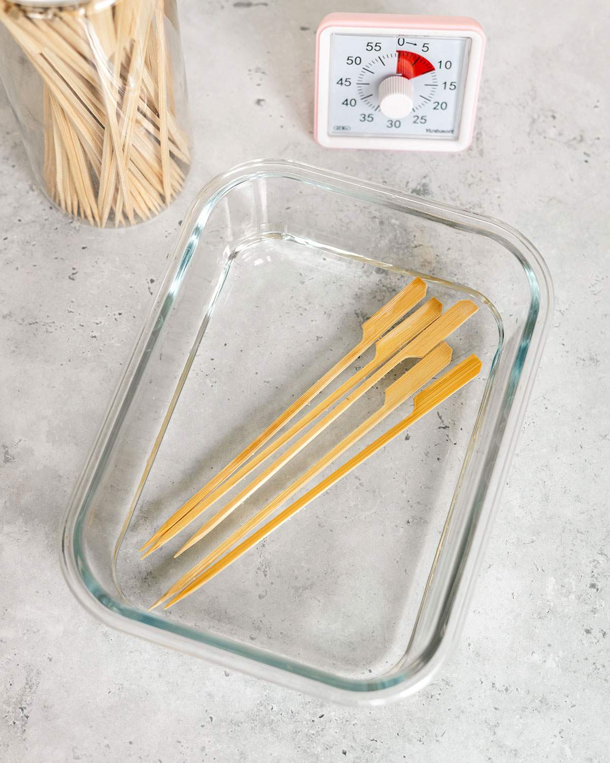 Wood skewers soaking in water before air frying.
