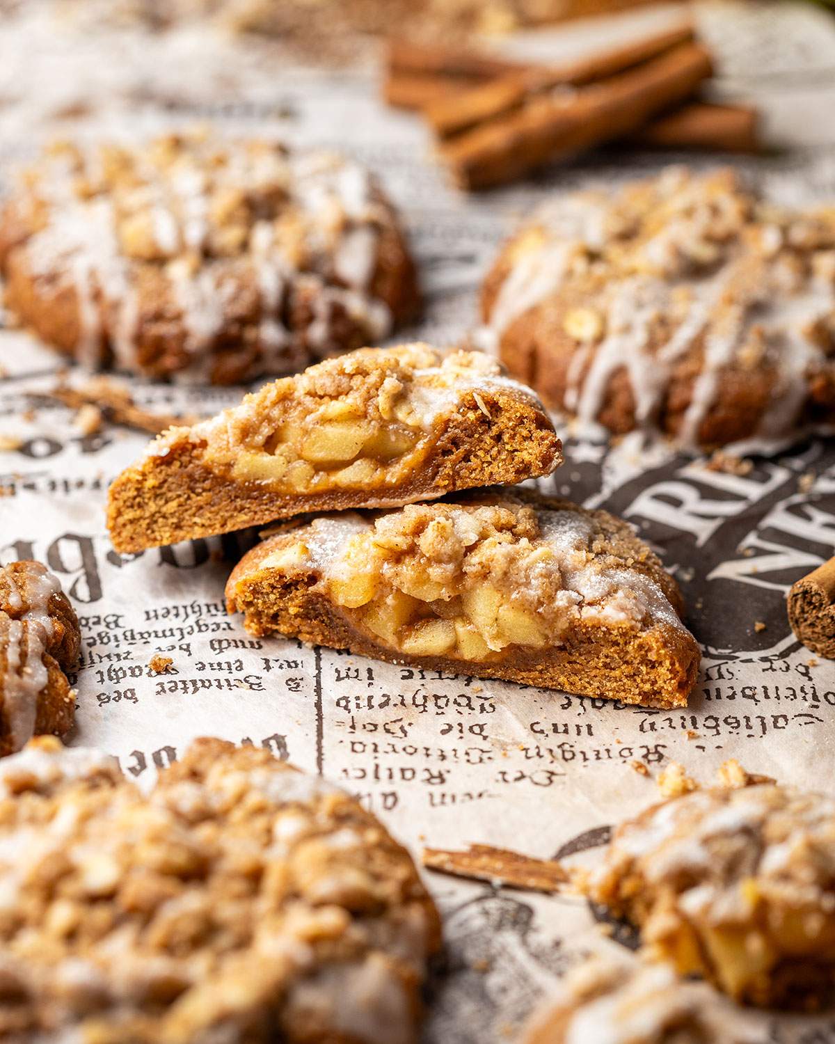A cut apple crumble cookie showing the spiced apple filling inside.