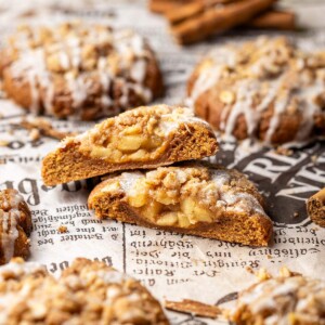 A cut apple crumble cookie showing the spiced apple filling inside.