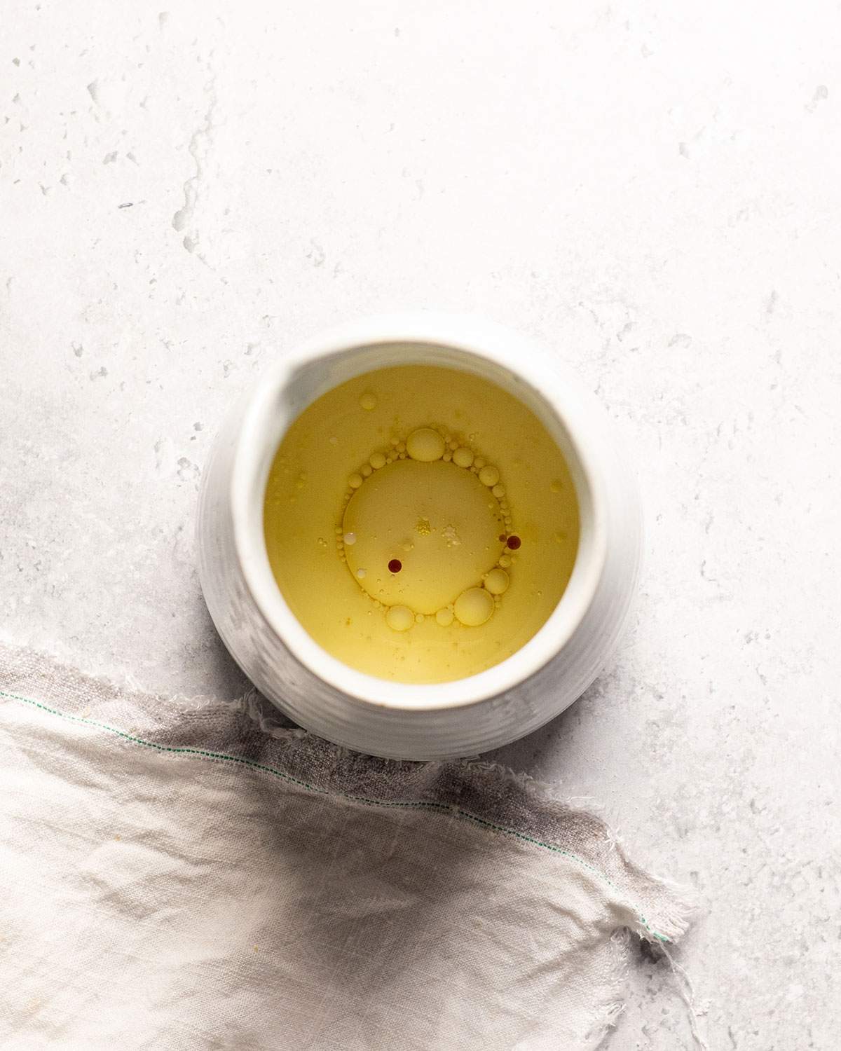 Wet ingredients mixed in a white ceramic jug.