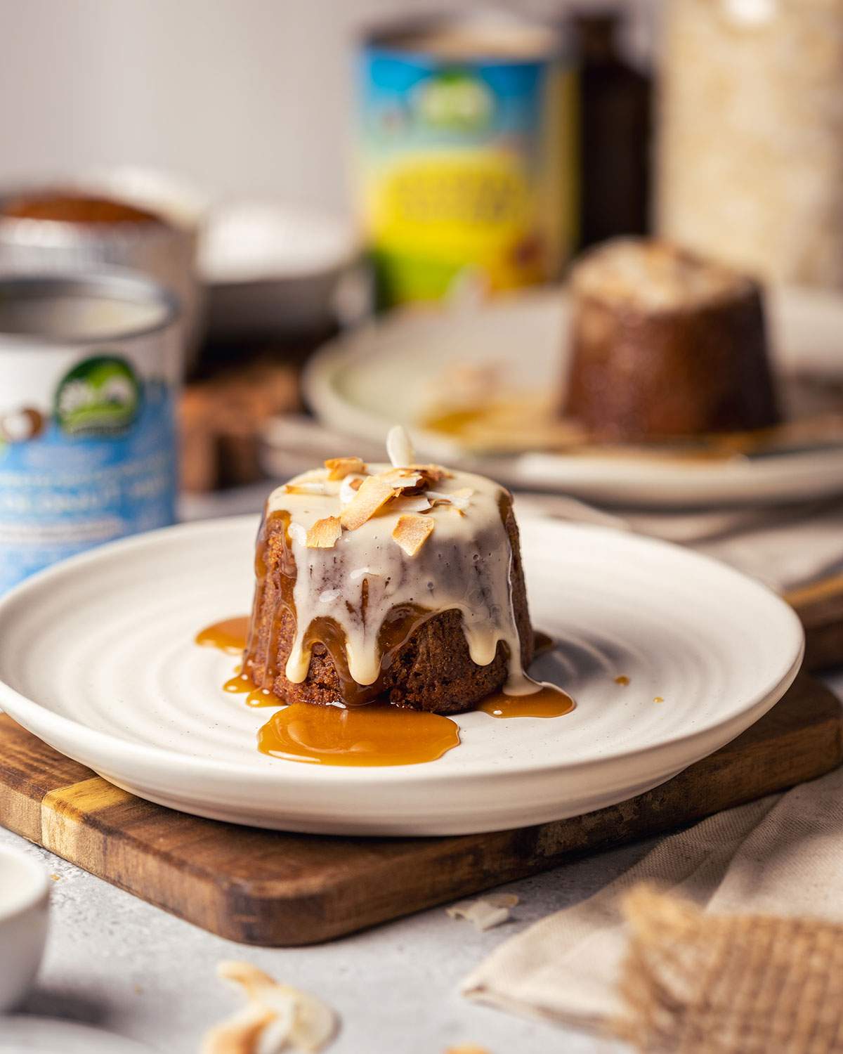 Mini sticky toffee pudding served plain on a white plate.