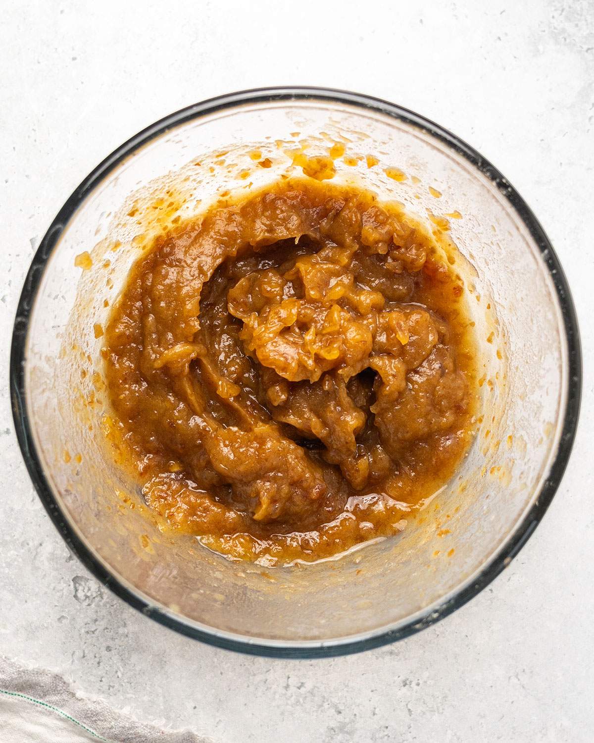 Date puree mixture in a glass bowl, ready to use in baking.