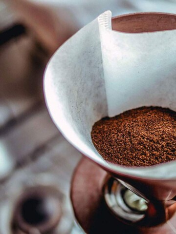 Coffee grounds in filter near kitchen sink.