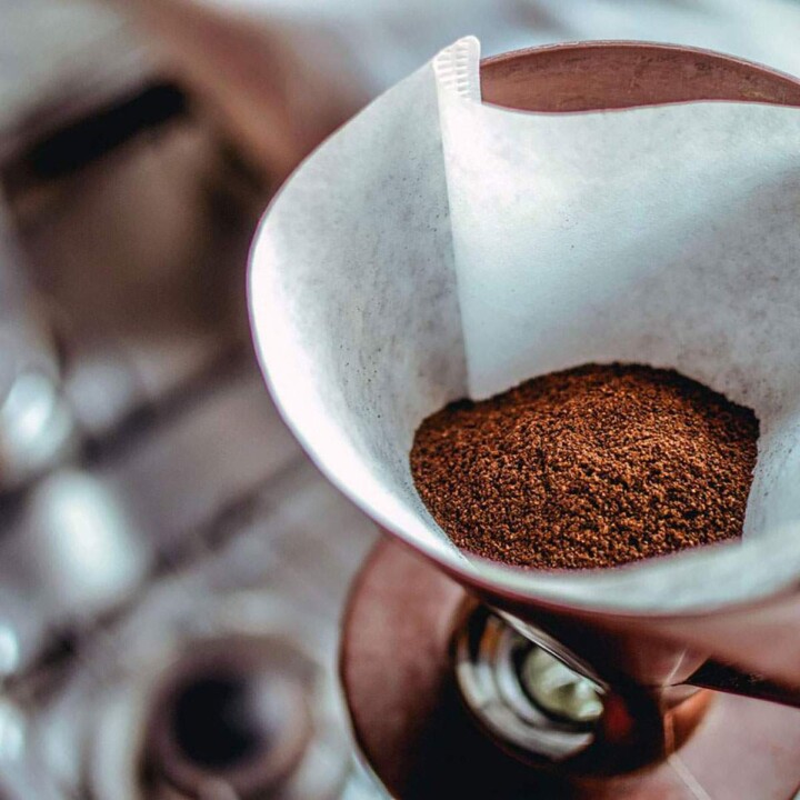 Coffee grounds in filter near kitchen sink.