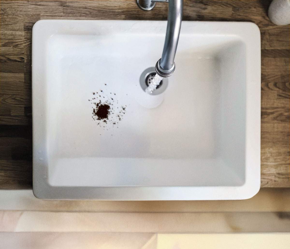 Used coffee grounds in kitchen sink.