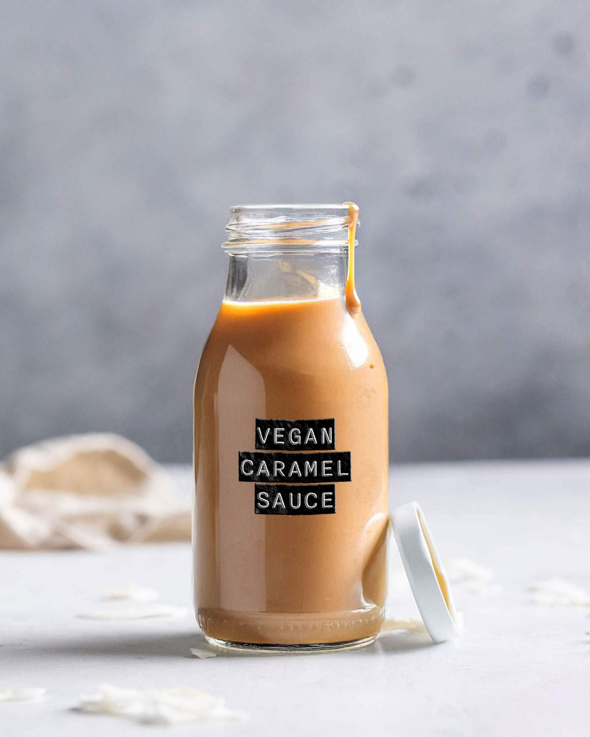 A labelled glass bottle with vegan caramel sauce.