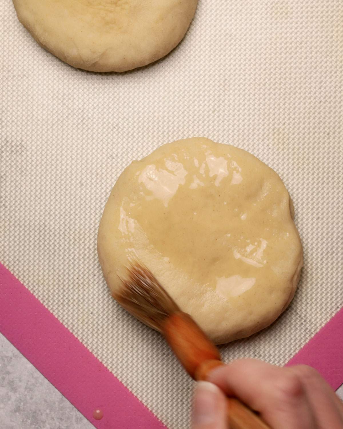 Brushing dough with a pastry brush.