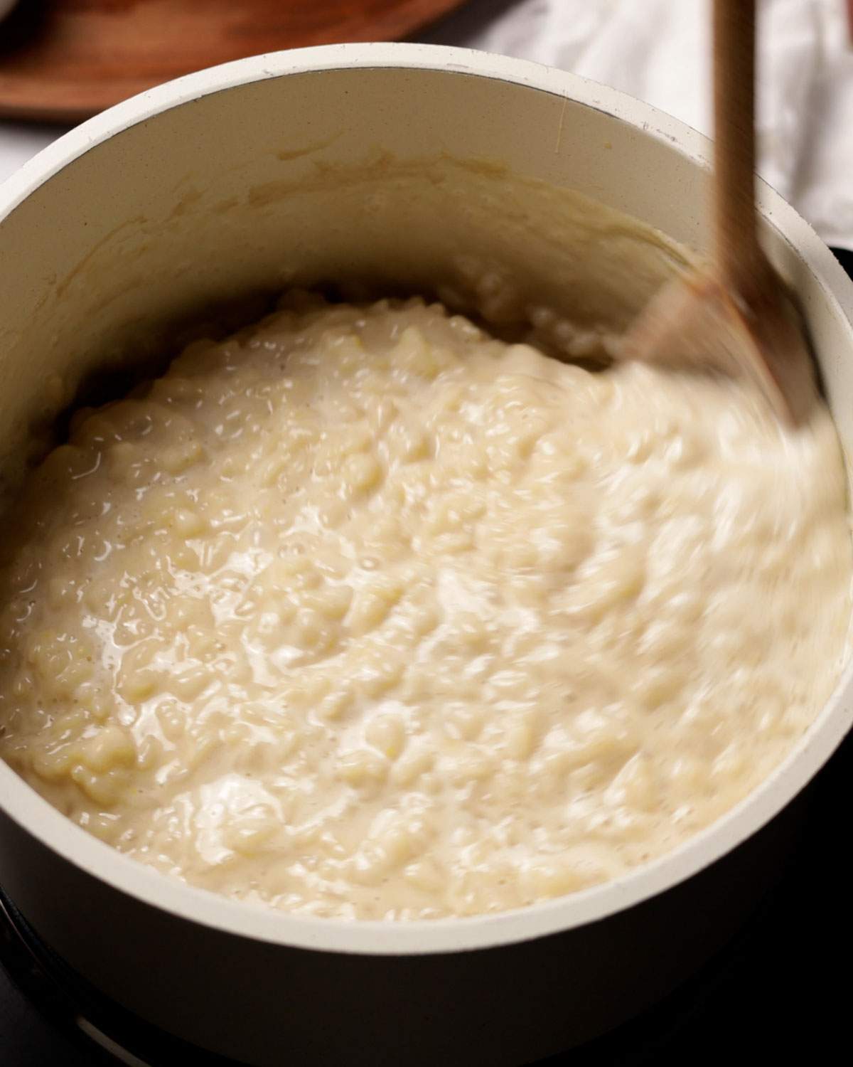 Stirring rice pudding in a saucepan.