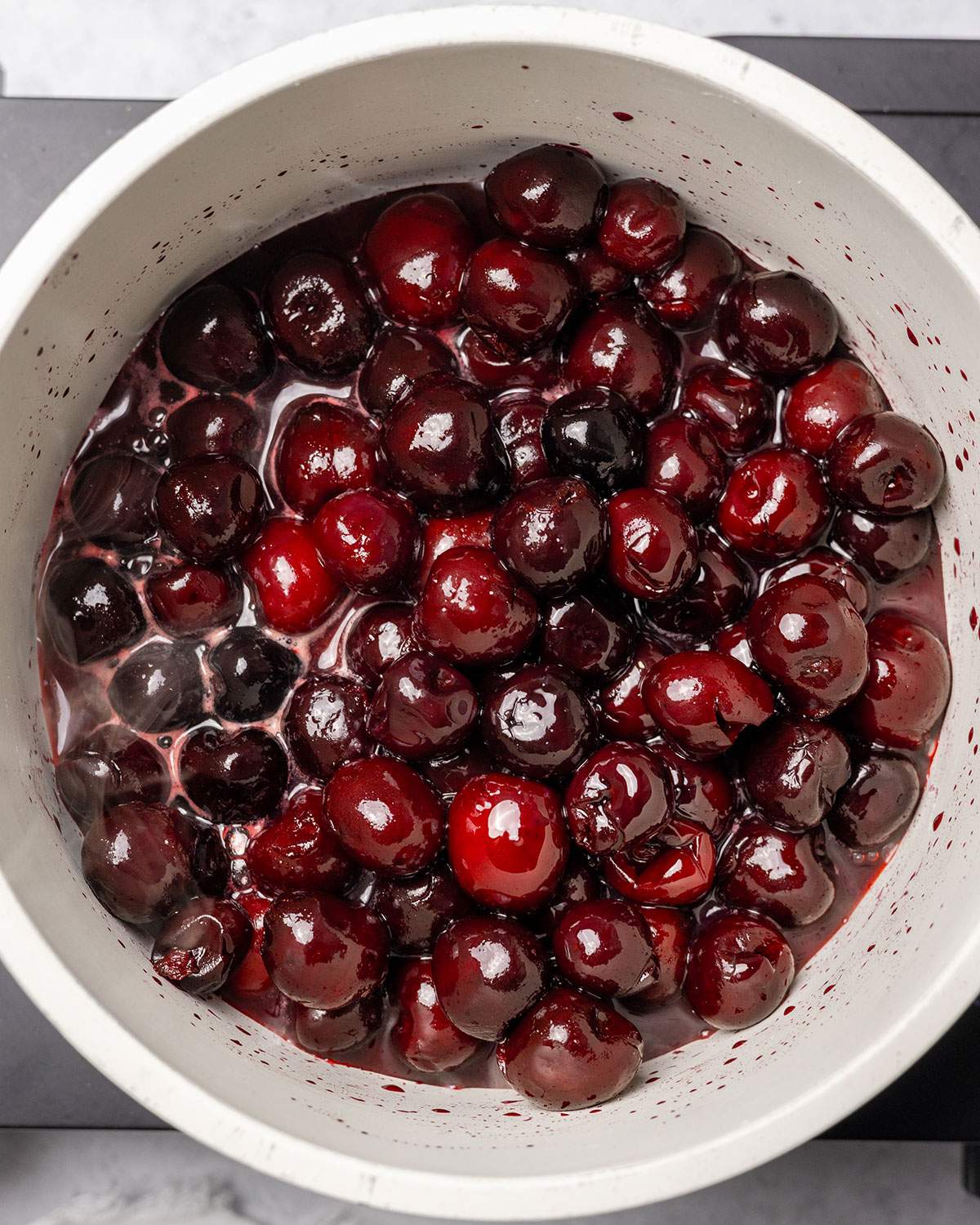 Ingredients for cherry compote on the stove.