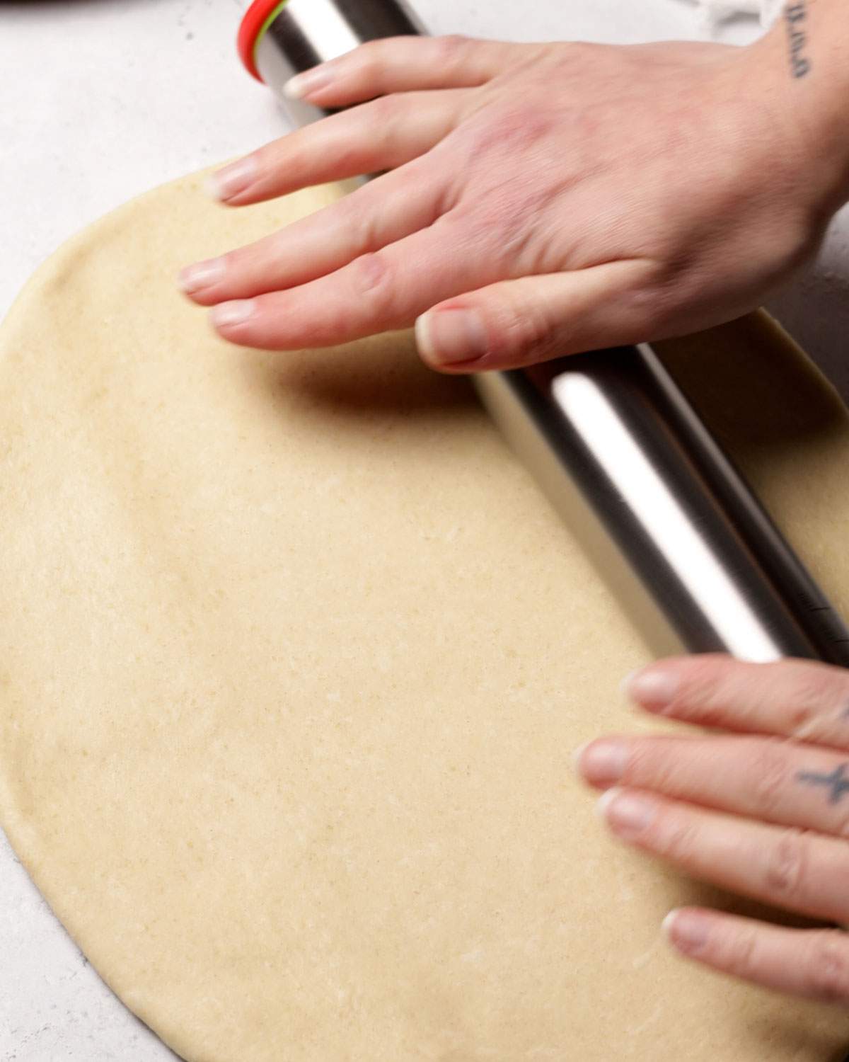 Rolling out yeast dough with a rolling pin.