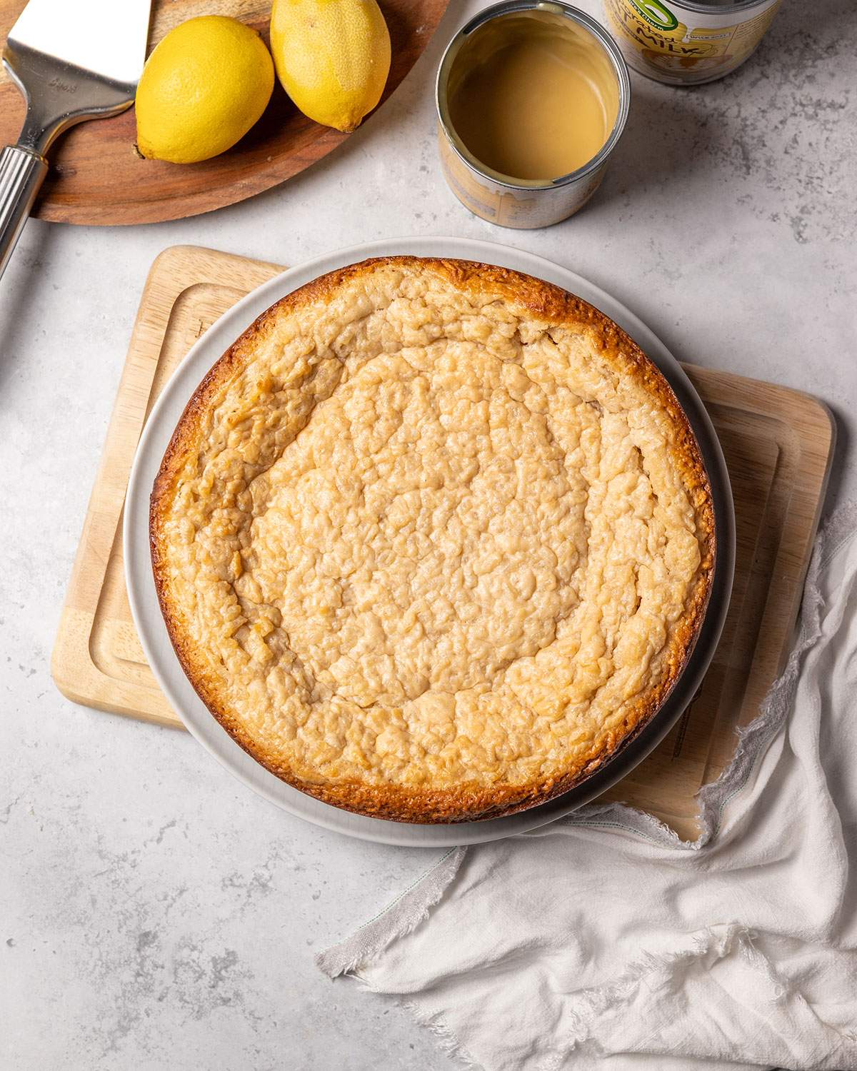 Baked vegan rice pudding cake on a serving plate after baking.