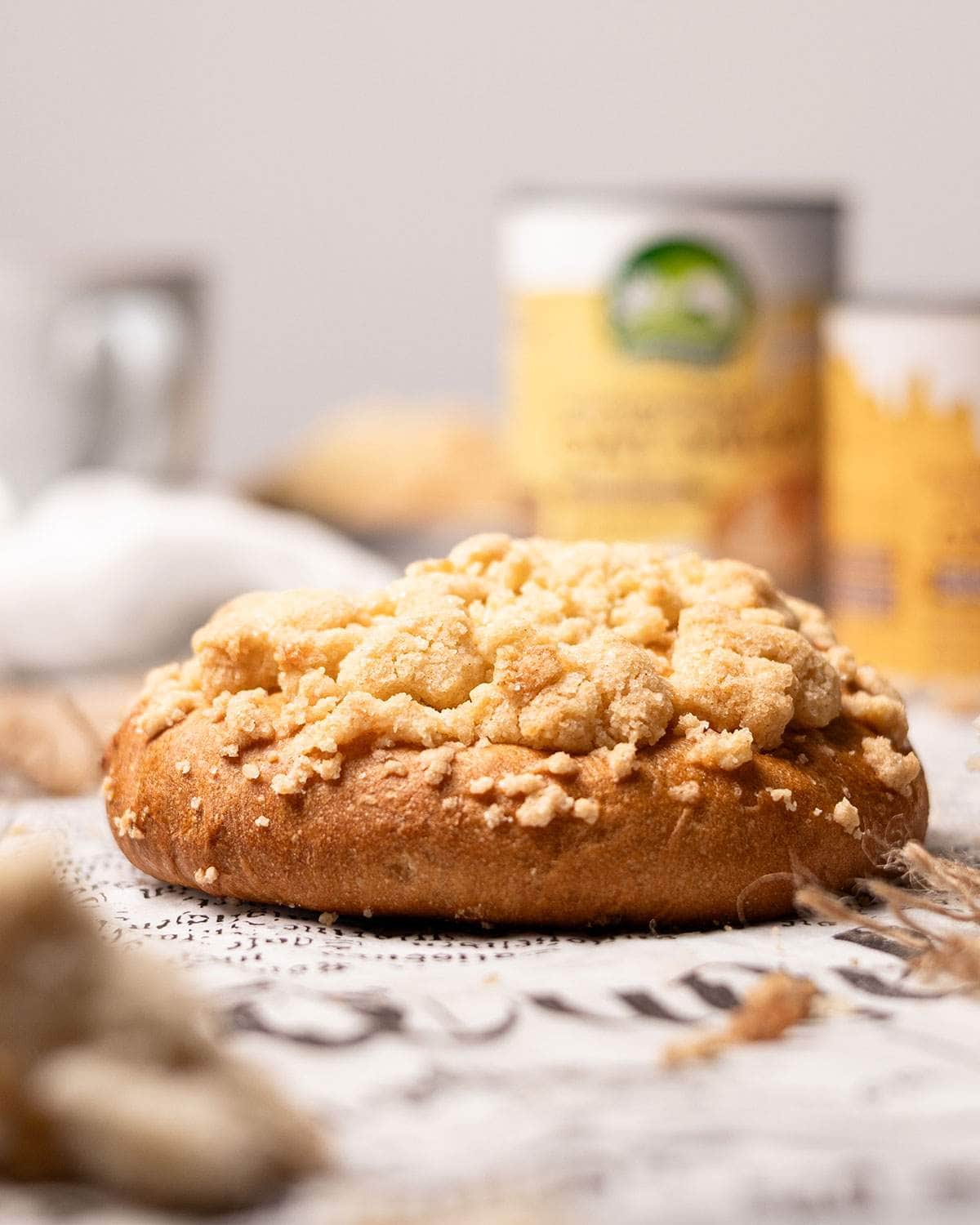 A vegan streuselbroetchen viewed side on, showing the fluffy height of the bake.