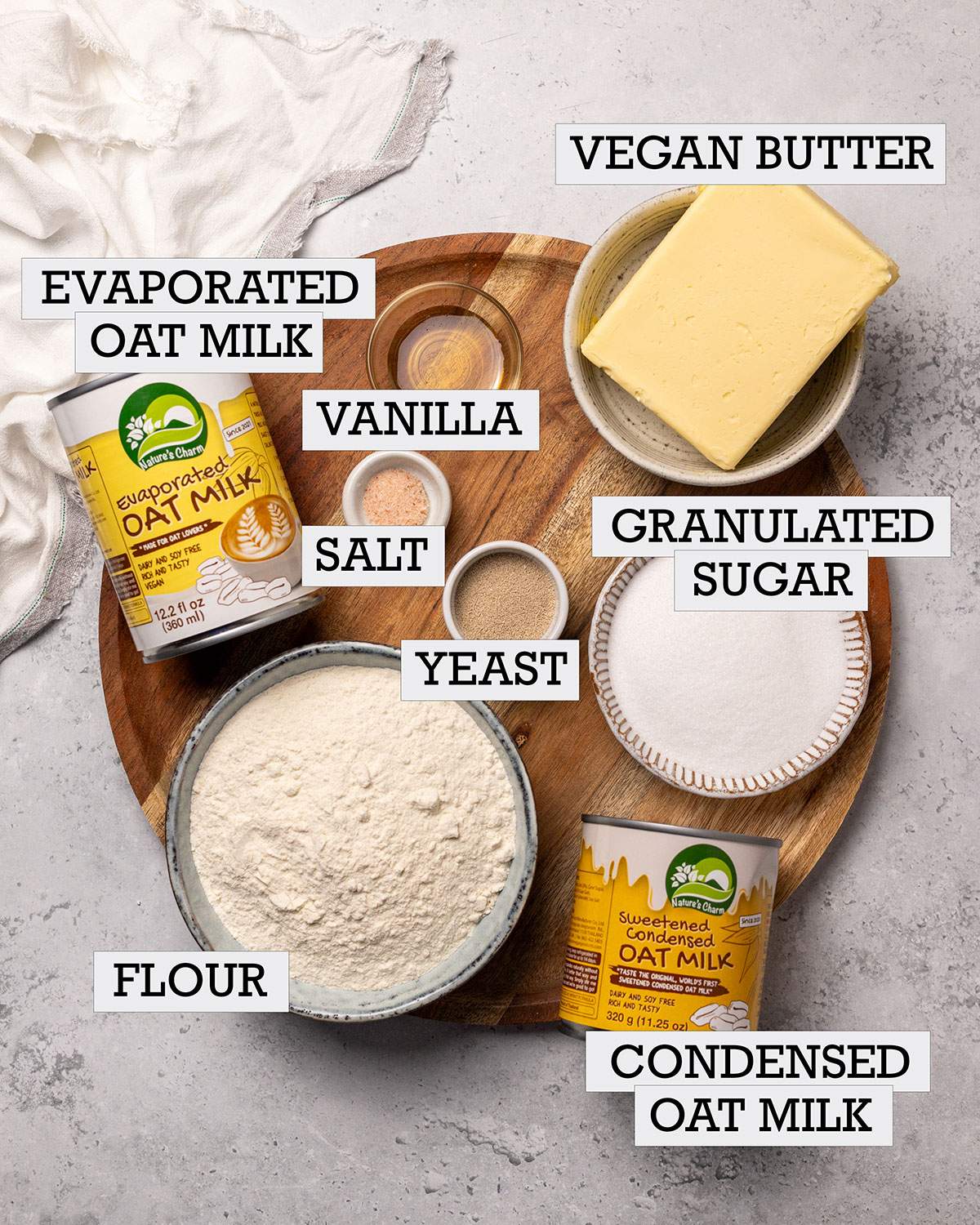 Ingredients for vegan streuselbroetchen aka vegan crumble rolls on a platter with labels.